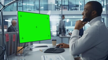Poster - Diverse Modern Office: Handsome Black IT Technician Using Desktop Computer with Green Chroma Key Screen. Engineer Administrator Work on e-Commerce Development, Project Marketing, Big Data Analysis