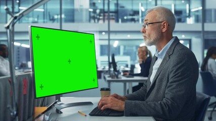 Poster - Handsome Senior Specialist Working on Desktop Computer with Green Chroma Key Screen Display in a Busy Corporate Office. Mature Male Manager Creatively Working In Multi-Ethnic International Workplace