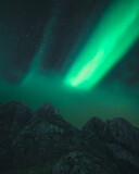 Fototapeta Kosmos - Northern lights known as aurora borealis over the arctic landscape in Norway. High quality photo
