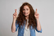 © gpointstudio - Redhead young woman showing cross fingers