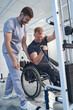 © Svitlana - Happy therapist treat wheelchair patient. Man with sport injury