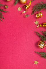 Wall Mural - christmas red background with decorative elements and green branches flat lay copy space