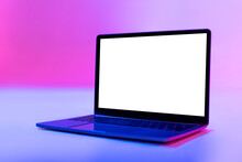 Modern Laptop Pc With Empty White Screen In Neon Light, Space For Website Or Desktop. Mockup