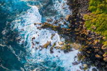 Aerial View Of Ocean Waves Breaking On The Rocks Along The Wild Coastline In Petite Ile, Saint Pierre, Reunion.