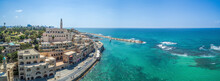 Panoramic Aerial View Of A Tourists Ship Enters The Old Jaffa Harbour And The Surrounding Buildings, Tel-Aviv Jaffa, Israel.