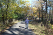 © John - Middle-aged man walking on the North Branch trail in autumn at Blue Star Memorial Woods in Glenview, Illinois
