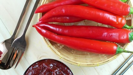 Wall Mural - Korean pepper paste and red pepper in wooden plate, Gochujang Korean traditionl Chili paste on a wooden table background. 4K