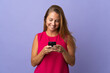 © luismolinero - Middle age brazilian woman isolated on purple background sending a message or email with the mobile