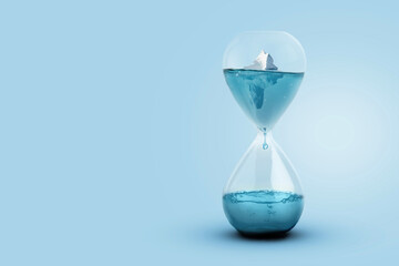 Wall Mural - greenland glacier melting and global warming concept. iceberg melting in a glass hourglass, time and