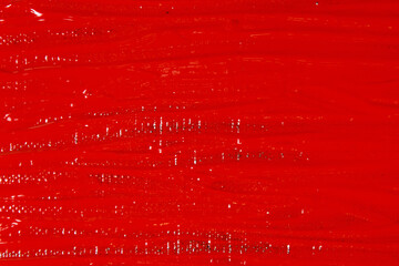 abstract creative background: red spots, strokes and splashes of colored primer when toning a black canvas, a temporary object.