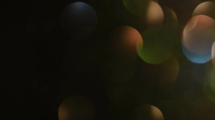Wall Mural - Soft round bokeh moves diagonally upward. Bokeh HD Loop. Movement and shimmers of brown bokeh with highlights of green and blue.