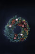 Christmas wreath made of natural blue spruce on a black background