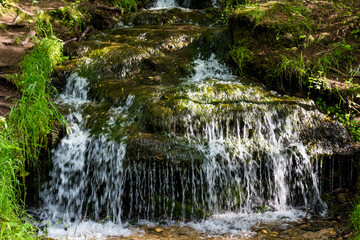  Small waterfall on a forest stream, a picturesque natural monument