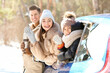 © Pixel-Shot - Happy family with car in forest on winter day