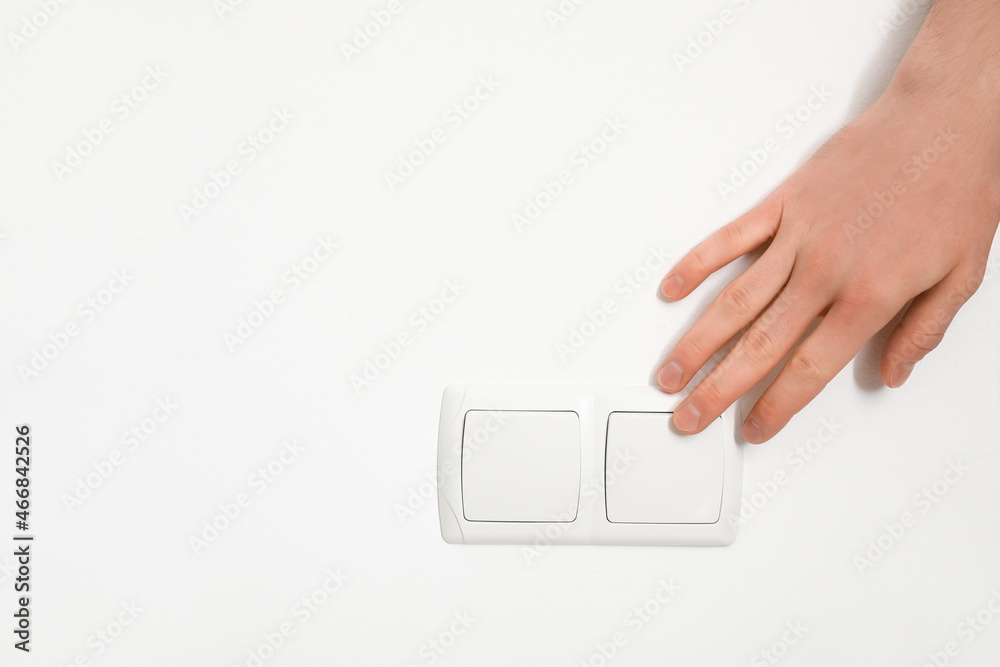 Woman switching on light in room, closeup