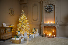 Room Decorated To Christmas Celebration Rental Studio. Room Decorated To Christmas Celebration Studio. White Christmas Tree With White And Gold Balls In A Dark Room With A Decorative Fireplace And Can