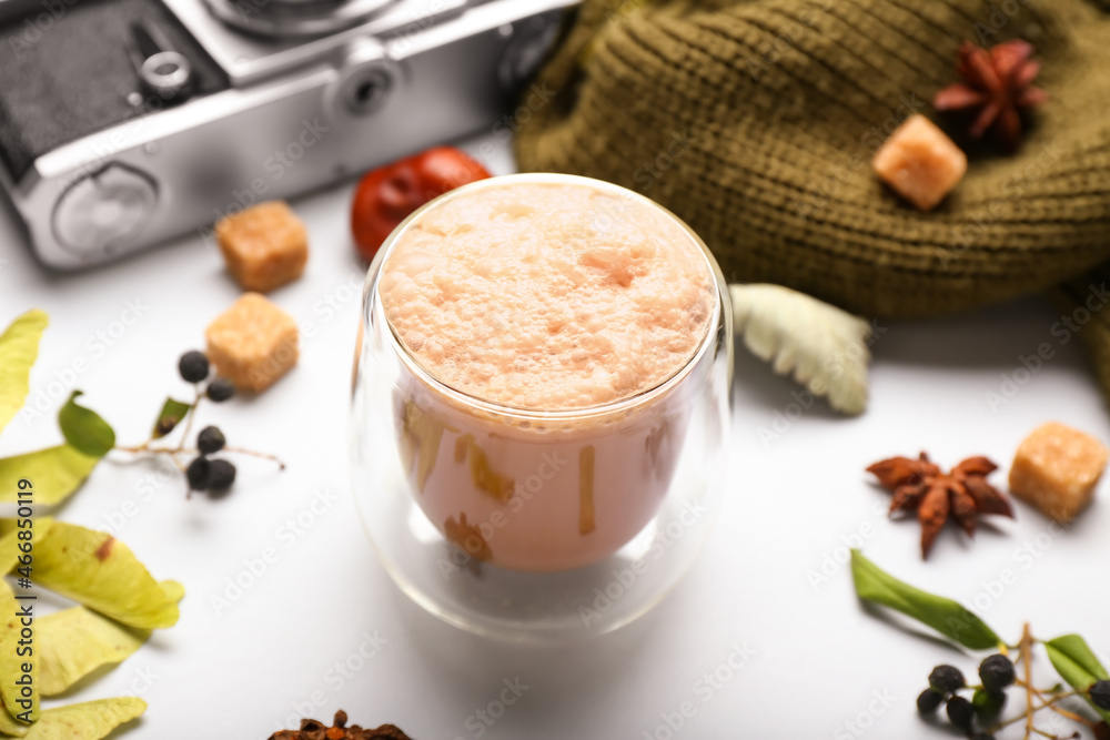 Autumn composition with cup of coffee on light background