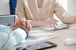 © DragonImages - Hands of entrepreneur listening to ideas of his female colleagues at meeting