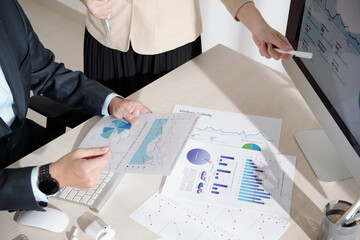 Wall Mural - Business people working with chart and report showing performace of company and activity of its subdivisions