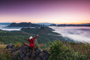 Young woman  in red  jacket touring on high  mountain, Ban Cha Bo, Mae Hong Son  province, Thailand.