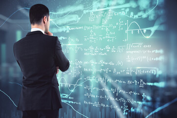 Wall Mural - Thoughtful young european businessman in blurry office interior looking at glowing mathematical formulas hologram. Digital knowledge and online education concept. Double exposure.