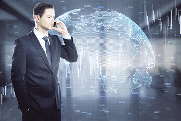 Poster - Attractive young european businessman using phone in blurry office interior with glowing globe hologram. Communication and big data concept. Double exposure.