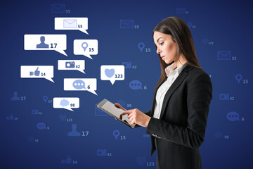 Poster - Attractive young european businesswoman using tablet with creative social media icons on blue background. Like, network, technology and communication concept.