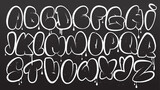 Fototapeta Młodzieżowe - Graffiti alphabet. Bubble graffiti letters outline. White uppercase letters with texture effect, drips, and spray effect on dark background. Graffiti font.