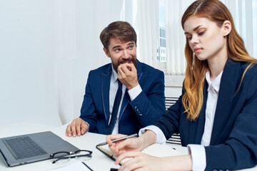 Poster - business man and woman chatting in the office in front of a laptop technology