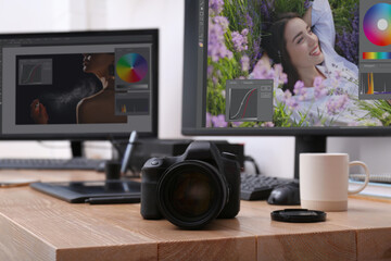 Fototapete - Retoucher's workplace. Professional camera on wooden table indoors
