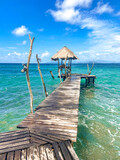 Fototapeta Pomosty - Wooden beach bar in sea and hut on pier in koh Mak island, Trat, Thailand