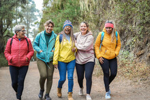 Multiracial Women Having Fun During Trekking Day Into The Wood - Escape To The Nature And Travel Concept - Focus On African Woman Face