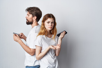 Wall Mural - married couple family with phones in hand communication isolated background