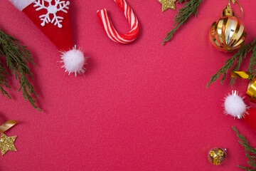 Wall Mural - christmas red background with decorative elements and green branches flat lay copy space