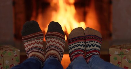 Wall Mural - Couple in Christmas socks near fireplace