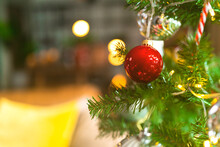 Christmas Background - Baubles And Branch Of Spruce Tree,Shiny Christmas Red Ball Hanging On Pine Branches With Festive Background,Closeup Of Red Bauble Hanging From A Decorated Christmas Tree