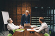© BullRun - Serious colleagues talking while working together