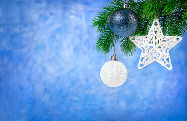 Canvas Print - christmas balls and star hang on fir branch on blue background