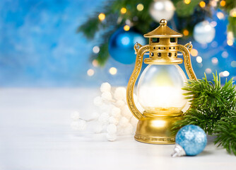 Canvas Print - lantern with a candle fir branch and christmas decorations on a table on a background of a christmas tree