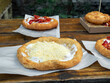 Langos with sour cream and grated cheese on wooden table. Langos - deep-fried flatbread, traditional hungarian food. Budapest, Hungary.