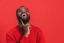Black Bearded Man Wearing Sweater Laughing And Looking Upward