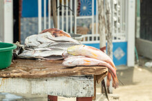 Preparing Fish In The Foreground For Sale. Colombia.