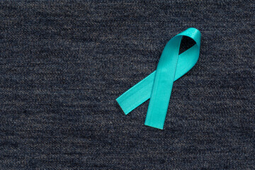 Wall Mural - blue ribbon with bow on blue jeans background. Blue november. Prevention of prostate cancer. men's health