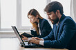 © SHOTPRIME STUDIO - business man and woman sitting at a desk with a laptop communication finance professionals