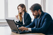 © SHOTPRIME STUDIO - colleagues sitting at a desk with a laptop communication finance officials