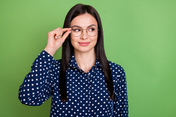 Wall Mural - Photo of nice brunette hairdo intelligent lady look empty space wear spectacles blue shirt isolated on green color background