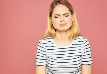 Wall Mural - blonde woman in a striped T-shirt discontent upset studio emotions