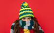 teen girl in knitted winter hat wear scarf on red background, cold weather