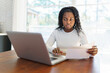© Louis-Paul Photo - Portrait of a young business woman with laptop working on the kitchen table look sad because of bill to pay