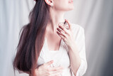 Fototapeta Las - girl sprays herself perfume on her neck